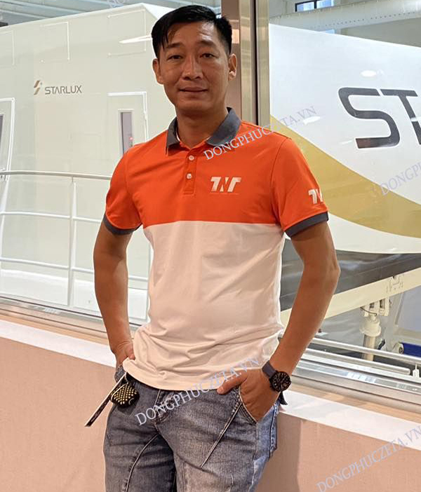 Áo đồng phục công ty TNT travel Vải lacoste piquecool Pro màu cam phối thân trắng