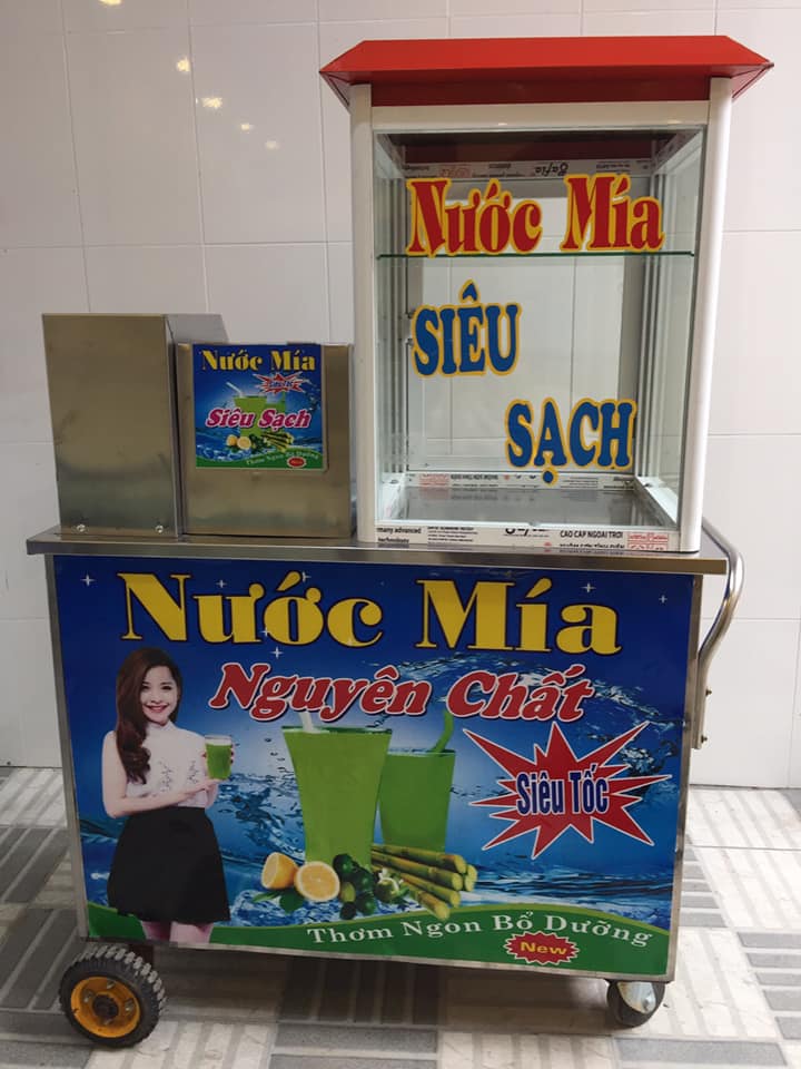 Máy ép mía siêu sạch lô to tủ kính trên nóc đỏ.