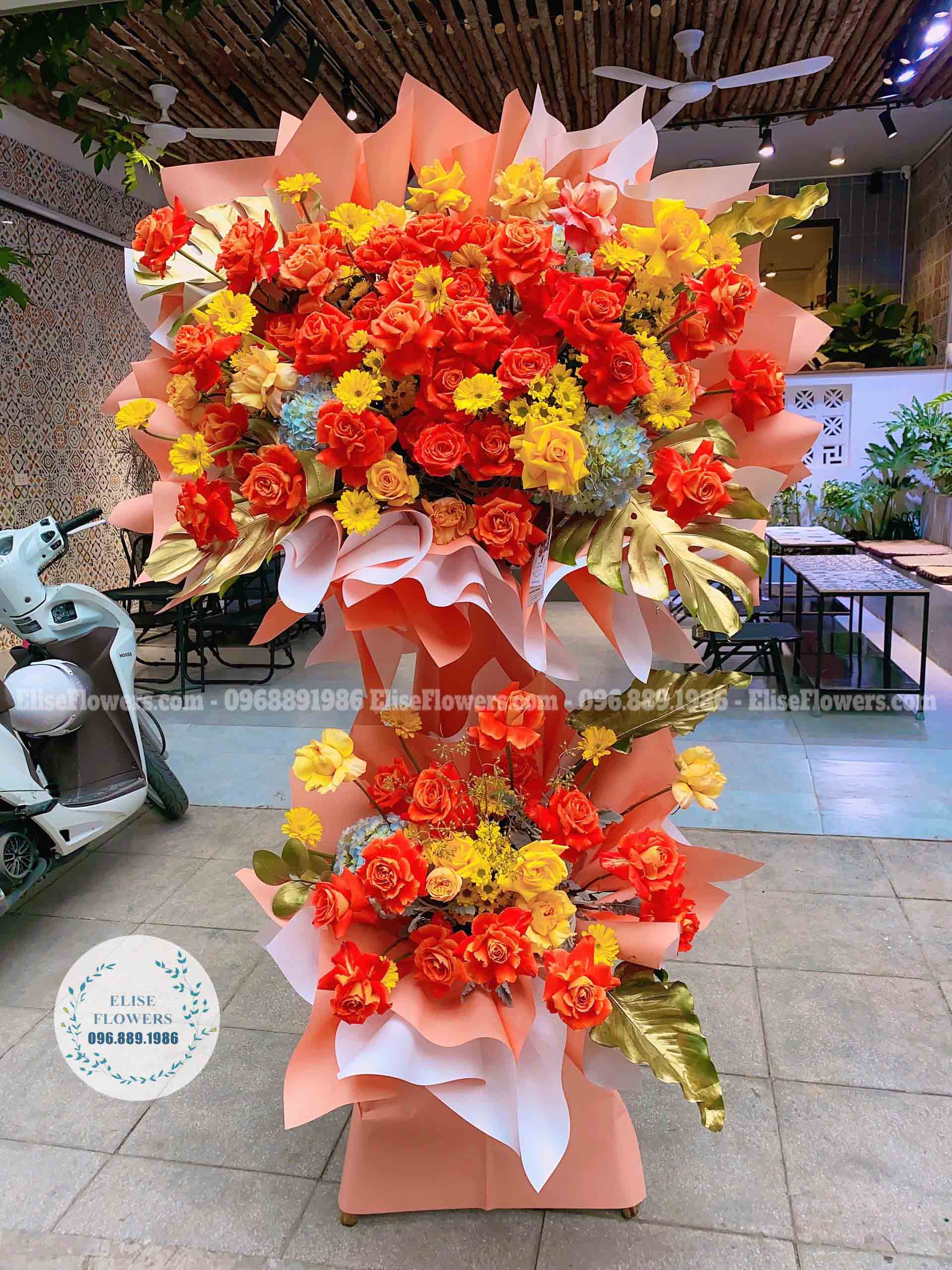 Kệ hoa 2 tầng màu cam sang trọng chúc mừng hội nghị, hội thảo | Dịch vụ điện hoa online - Giao hoa tận nơi tại quận Đống Đa - Hà Nội