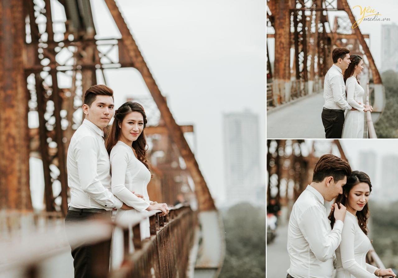 ảnh cưới chụp áo dài tại cầu long biên chú rể ôm phía sau cô dâu