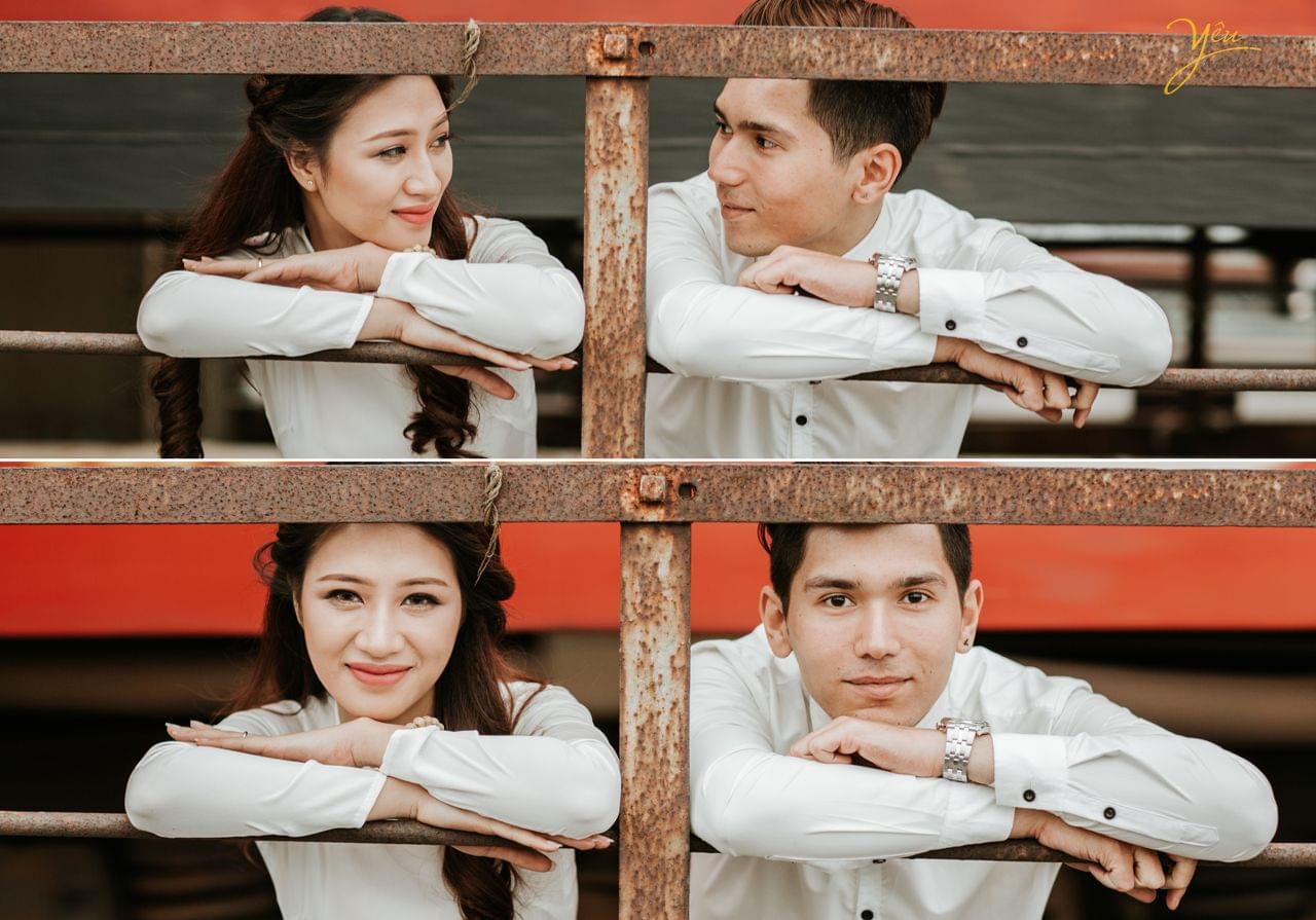 ảnh cưới cô dâu chú rể đứng tại song sắt thành cầu nhìn nhau