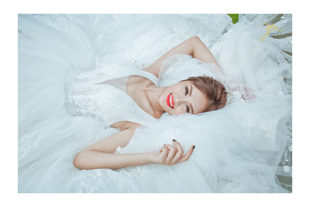 ảnh chụp cô dâu đơn nằm trên váy cưới