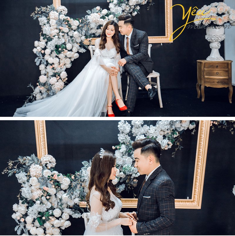 cô dâu chú rể chụp ảnh cưới phía trước bức tranh