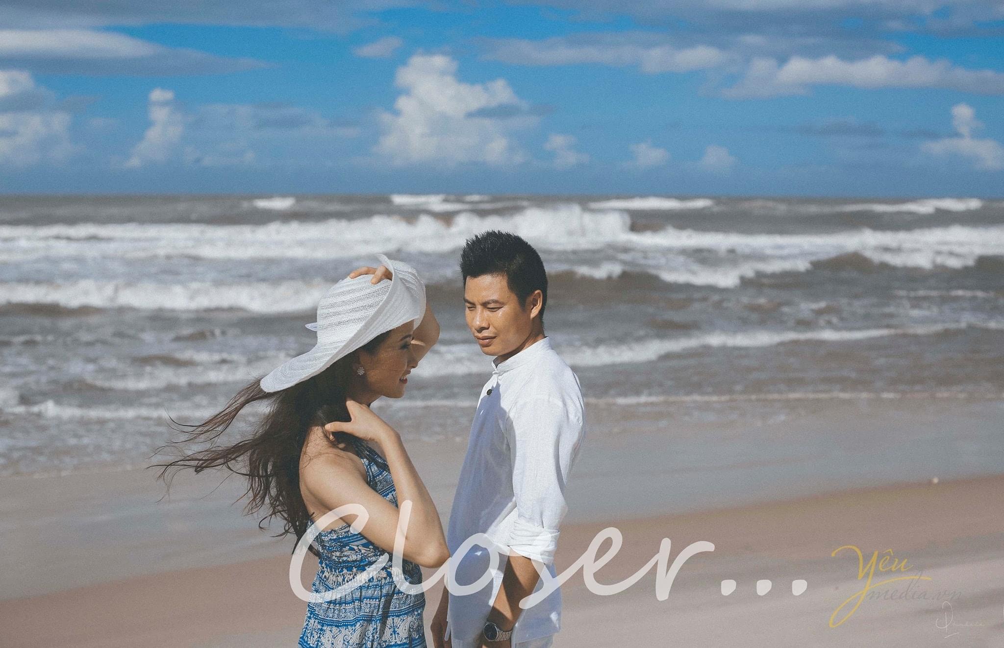 cô dâu chú rể đứng cạnh nhau trên biển