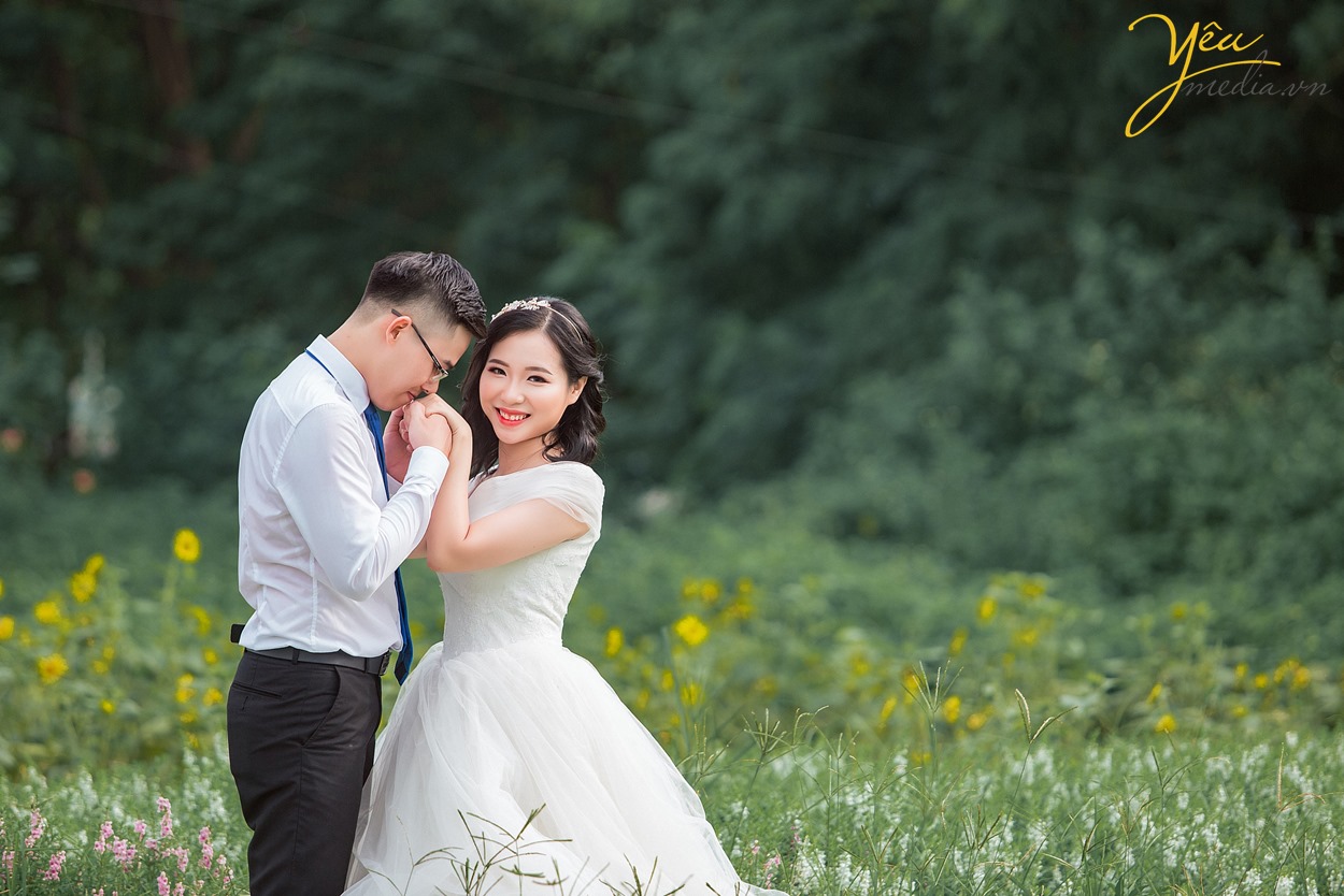 chú rể hôn lên bàn tay của cô dâu xinh đẹp