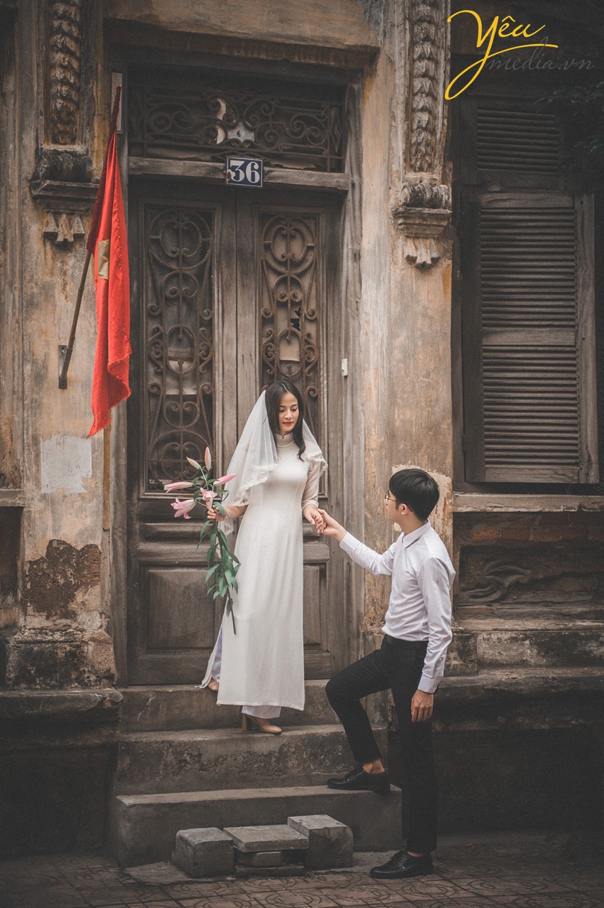 cô dâu chú rể chụp ảnh cưới ngoài cửa nhà