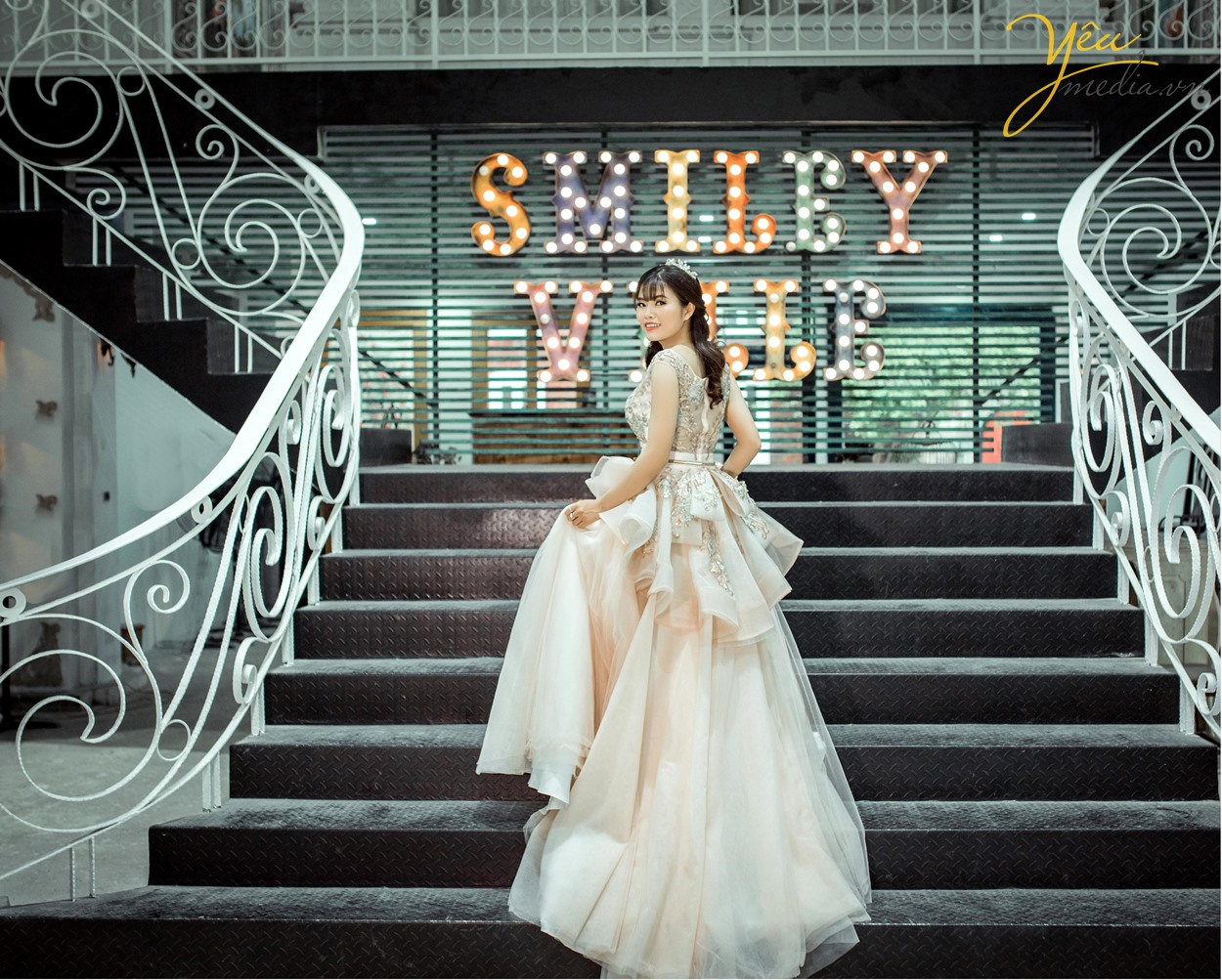 cô dâu chụp ảnh ở bậc cầu thang smiley ville phim trường