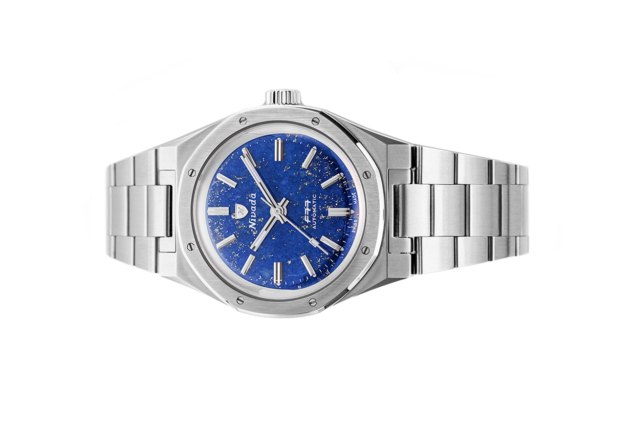 Đồng hồ đeo tay thương hiệu Nivada Grenchen, dòng sản phẩm F77, Ref number: 68009A77, mặt số đá Lapis Lazuli xanh dương nhạt size 37mm,máy tự động,dây và vỏ kim loại thép không gỉ 316L,mới 100%