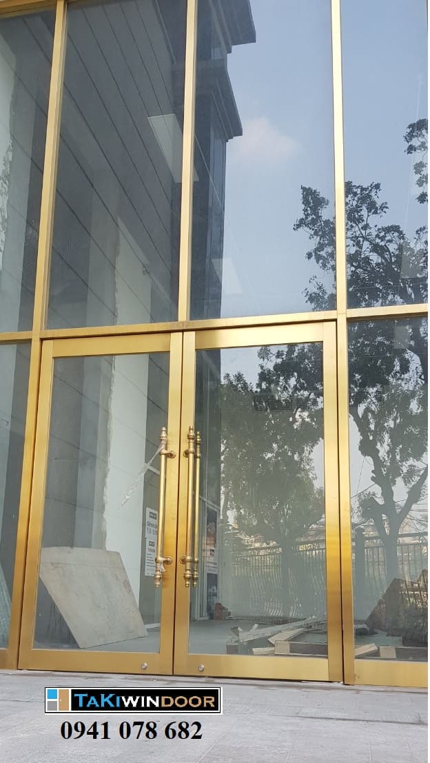 Thi công cửa kính khung inox vàng mờ xước