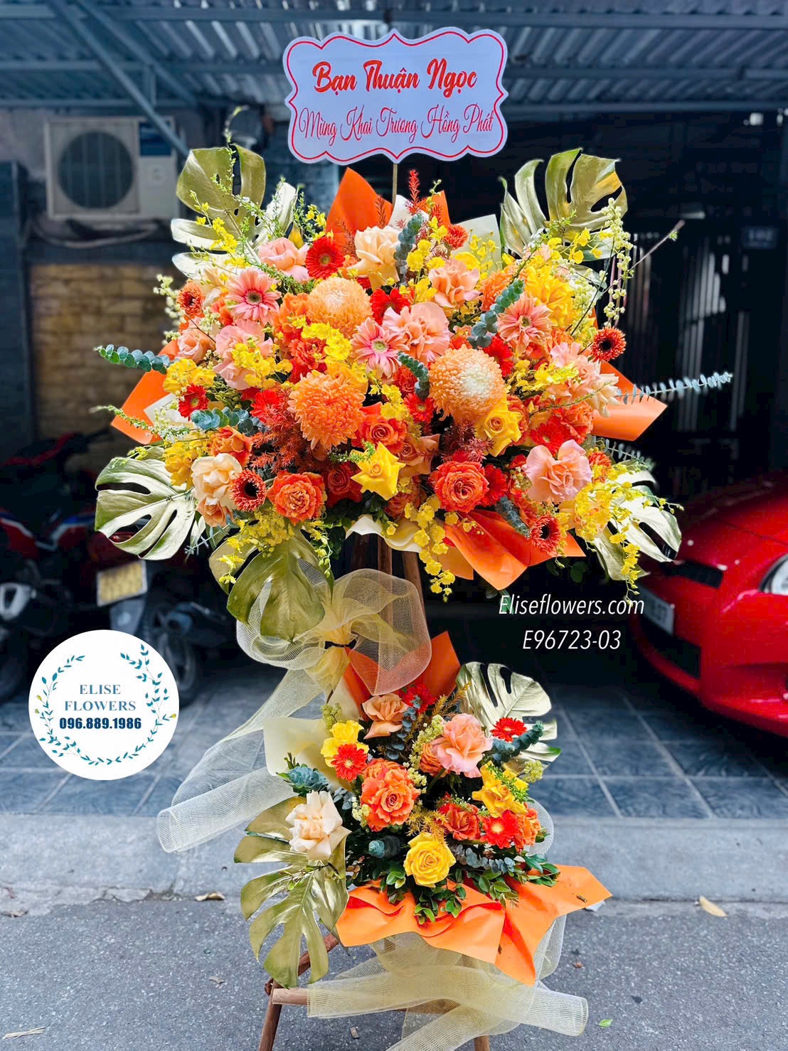 Hoa khai trương Cầu Giấy. Kệ hoa tone cam phú quý, tài lộc. Hoa chúc mừng sự kiện. Eliseflowers