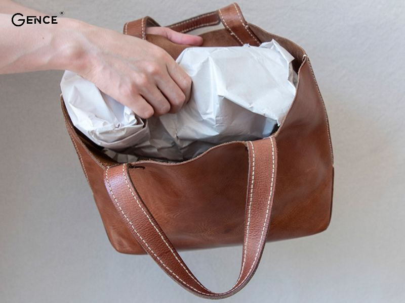 Bỏ giấy báo vào trong túi da