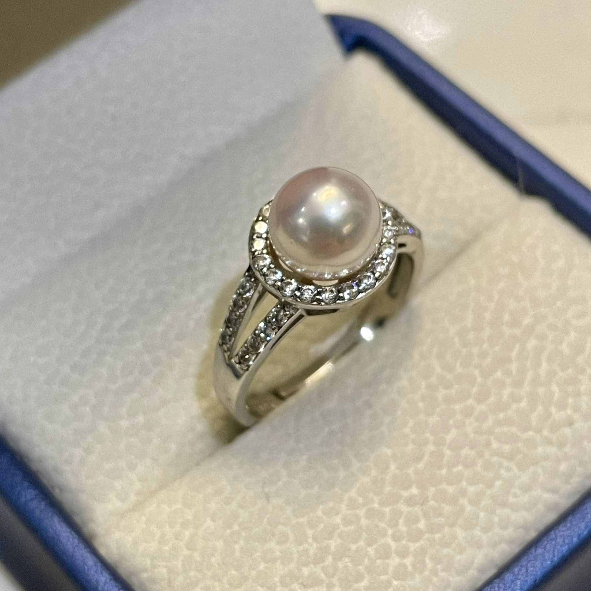 thiết kế viền đá lấp lánh ôm lấy viên ngọc sáng bóng như gương.