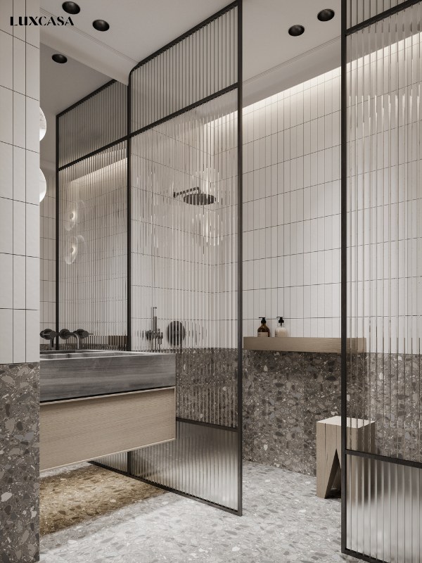 Nhà tắm ốp gạch thẻ màu trắng phần trên, ở dưới ốp và lát gạch terrazzo màu tối đem lại cái nhìn đối nghịch cực kỳ bắt mắt và gây ấn tượng mạnh