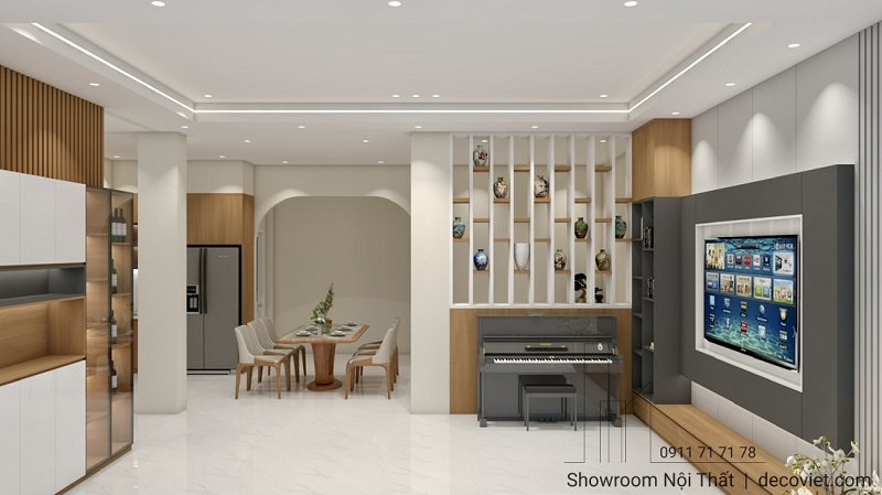 Phòng khách bố trí sofa trung tâm, kệ tivi ốp gỗ hiện đại.