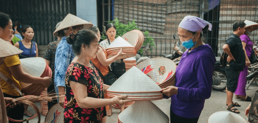 buying-conical-hat-in-the-village-rt-travel