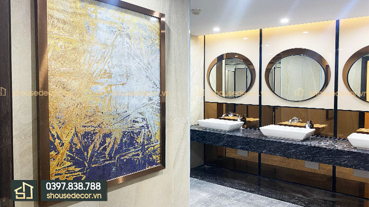 Khu vực bồn rửa, gương và tranh tranh trí cũng được bọc inox đồng hiện đại