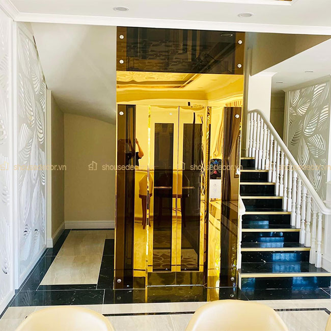 Sử dụng ốp inox vàng OTMKV06 phù hợp với thang máy kính phong cách hiện đại