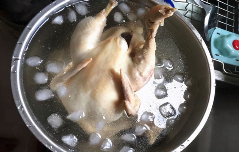 4: Gà đã luộc xong nên ngâm trong nước đá để thịt gà dai, da gà giòn hơn