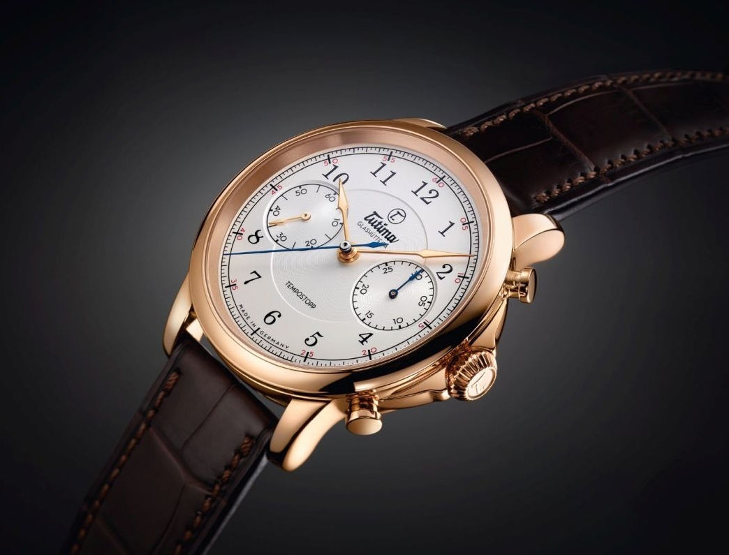 Đồng hồ đeo tay thương hiệu Tutima, dòng sản phẩm Tempostopp, Ref no: 6650-01, mặt số mạ bạc, size 43mm, máy lên cót tay , vỏ và khóa đồng hồ bằng vàng hồng 18k, dây đeo da cá sấu, hàng mới 100%