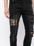 AMIRI appliqué-logo distressed-effect slim-fit jeans