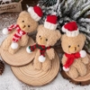 Gấu bông màu nâu gồm cả mũ và khăn (kt 7x 16cm).