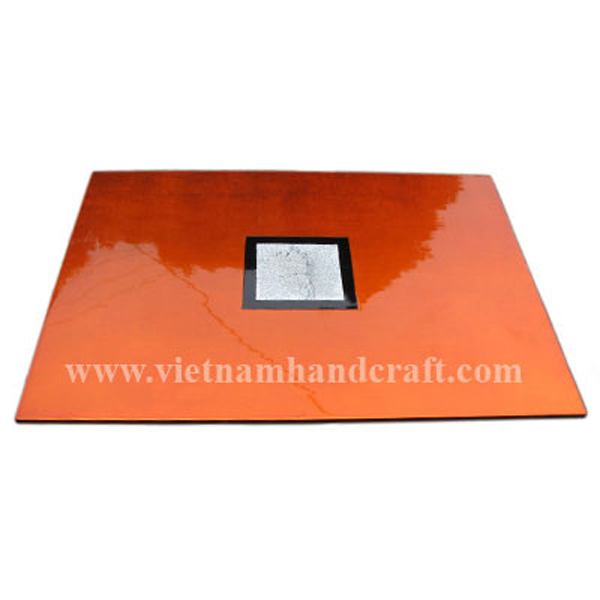 Handmade orange silver lacquerware placemat with eggshell inlay on black background in the center Handmade orange silver lacquerware placemat with eggshell inlay on black background in the center