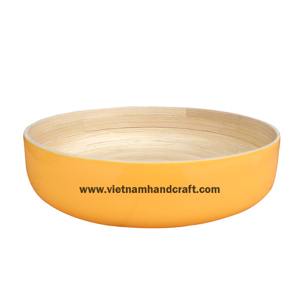 Handmade coiled bamboo fruit bowl. Inside in natural, outside in yellow Handmade coiled bamboo fruit bowl. Inside in natural, outside in yellow