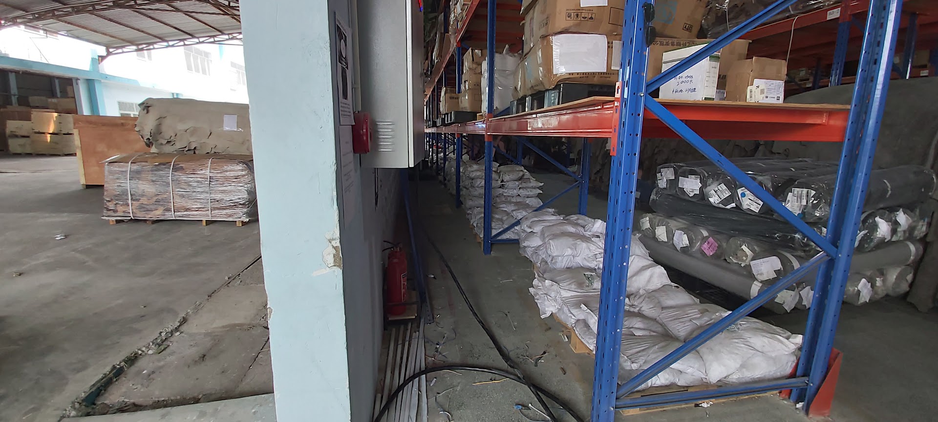 Kho vải nguyên liệu trong xưởng may với bình chữa cháy PCCC