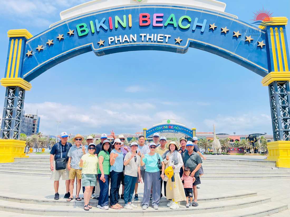 Đoàn khách Du Lịch Bình Minh chụp ảnh trước cổng chào Bikini Beach NovaWorld Phan Thiết
