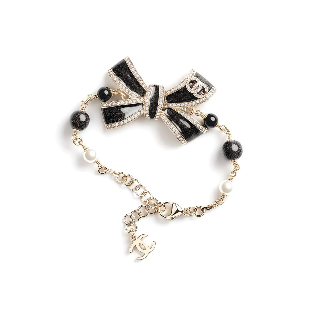 LẮC TAY CHANEL 25B NƠ VÀNG ĐEN ORNAMENT