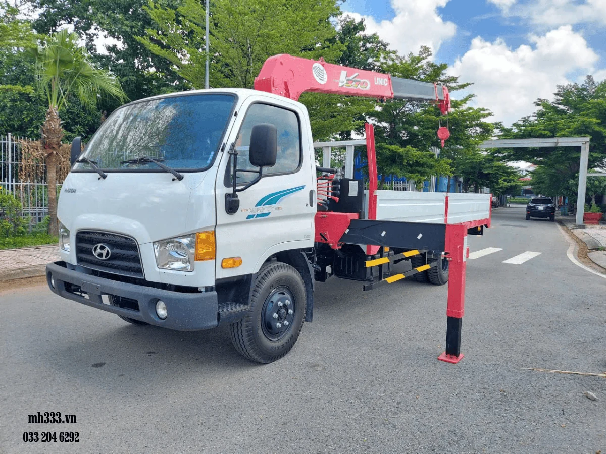 Xe tải Hyundai Mighty W11XL cabin trắng gắn cẩu Unic màu đỏ phía sau cabin, thùng lửng, nhìn chéo từ phía trước