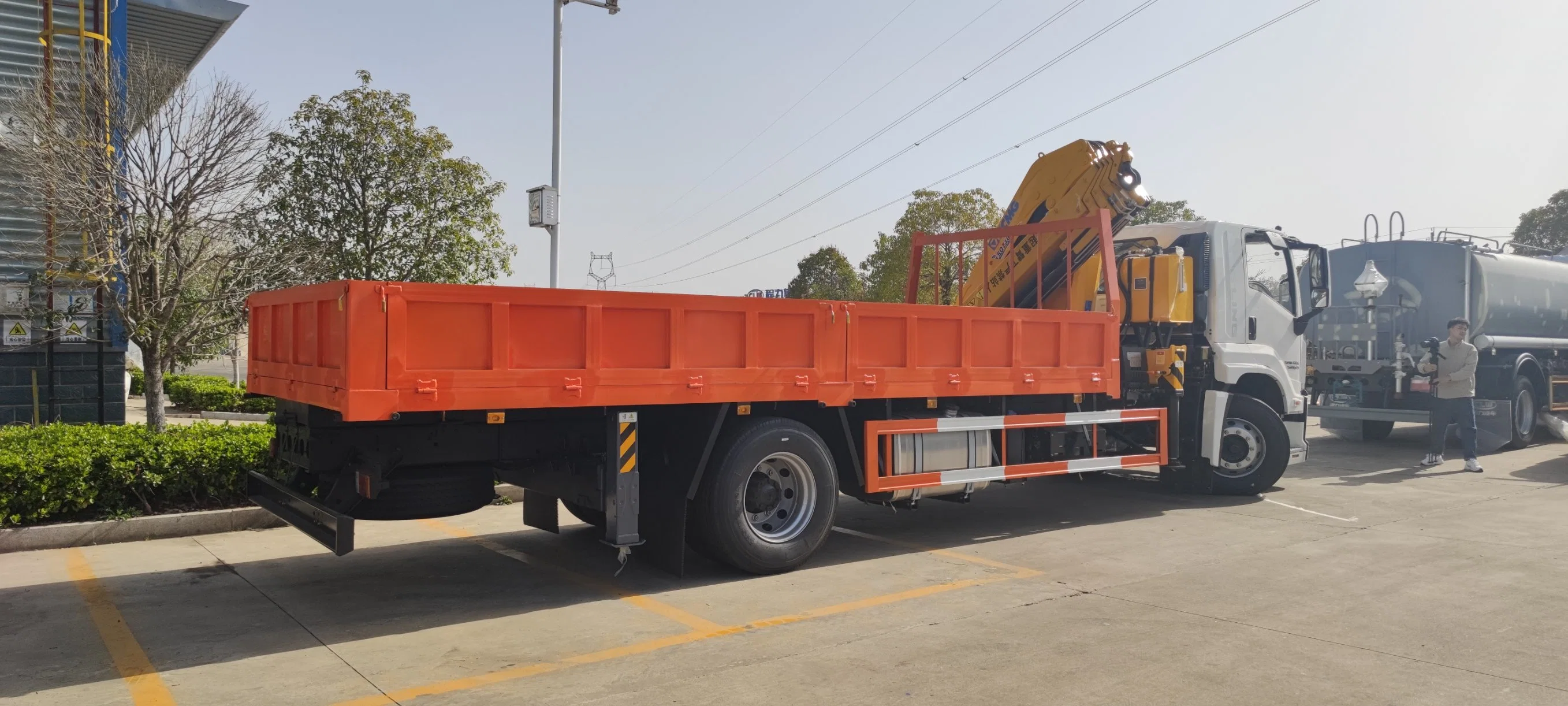 Xe tải Isuzu Giga gắn cẩu 8 tấn đang làm việc tại một công trường xây dựng, nâng các cấu kiện bê tông.