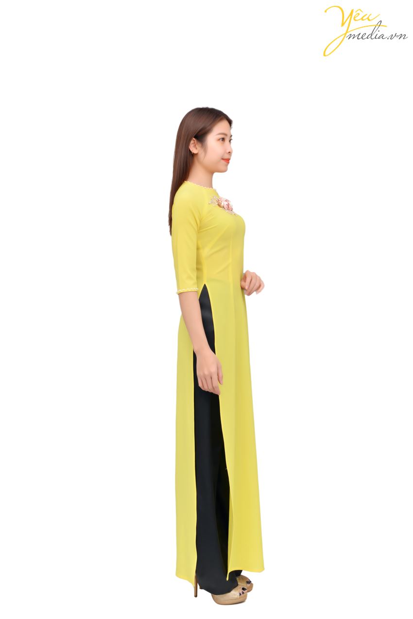 Áo dài 82 với màu vàng nhẹ nhàng và nhã nhặn - tạo ấn tượng cho người đối diện bởi hai bông hoa hồng sang trọng trên ngực áo. Đây là mẫu áo tay lửng, có cổ áo và cổ tay được điểm xuyết bởi viền ngọc trai. Mẫu áo dài 82 này được nhiều khách hàng tuổi từ 25 - 40 lựa chọn mặc trong những dịp sự kiện. 