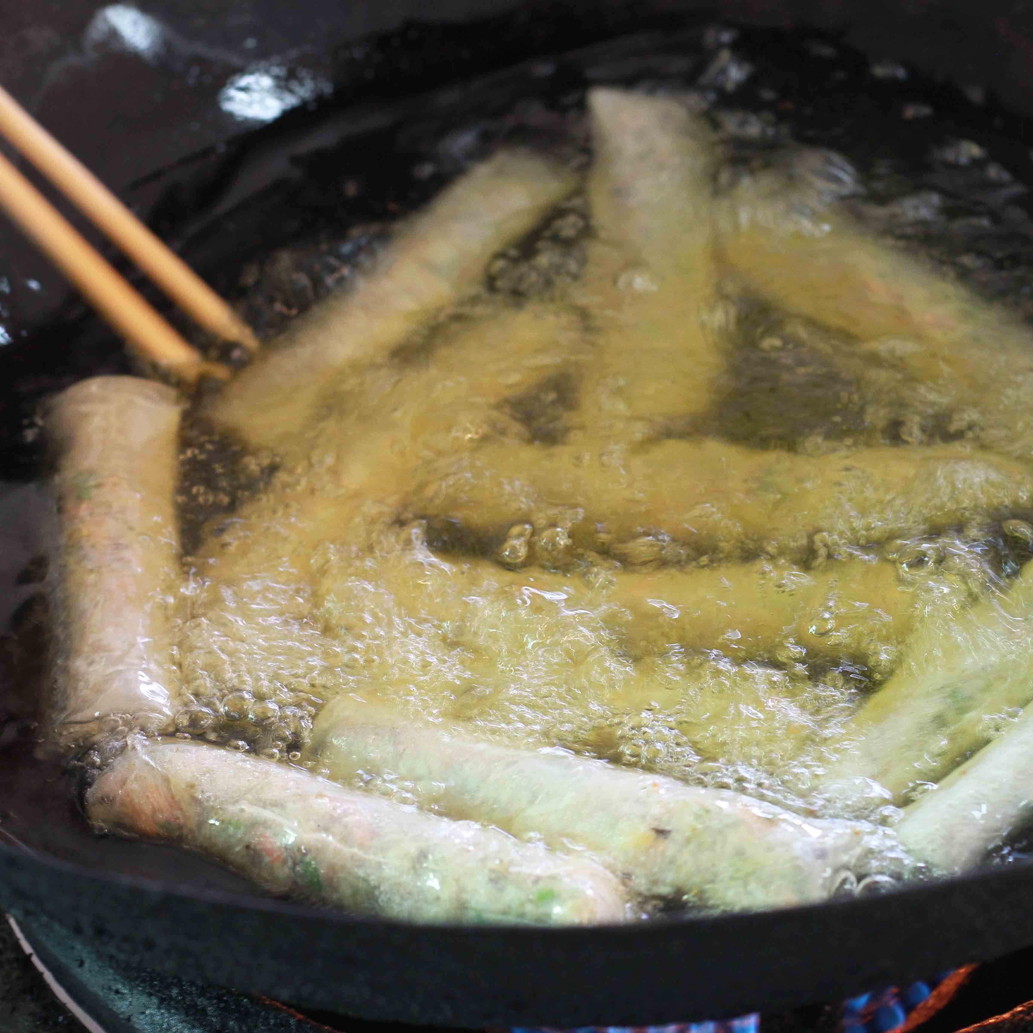 cooking fried spring rolls at Hoa Sua School