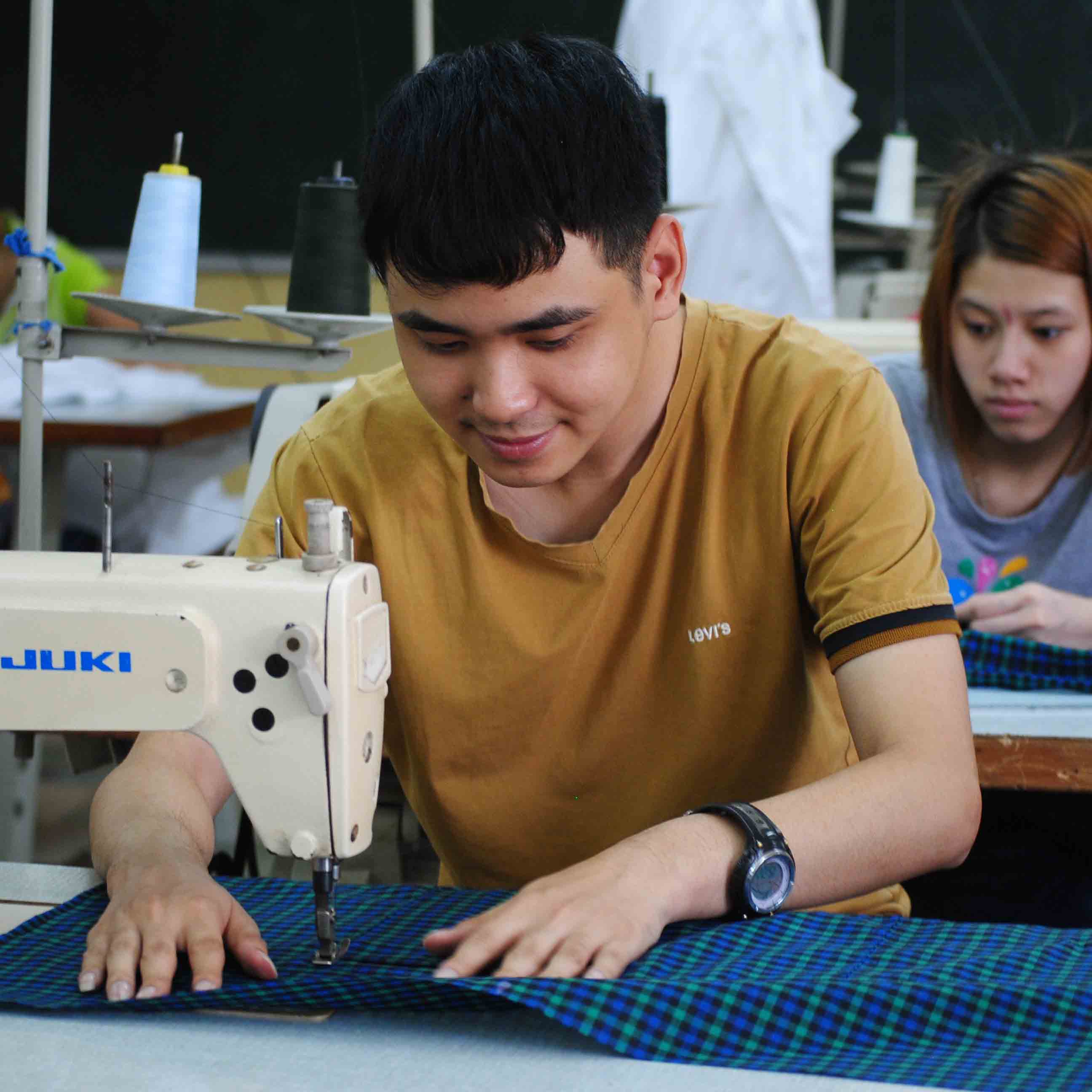 A student sewing in Hoa Sua school