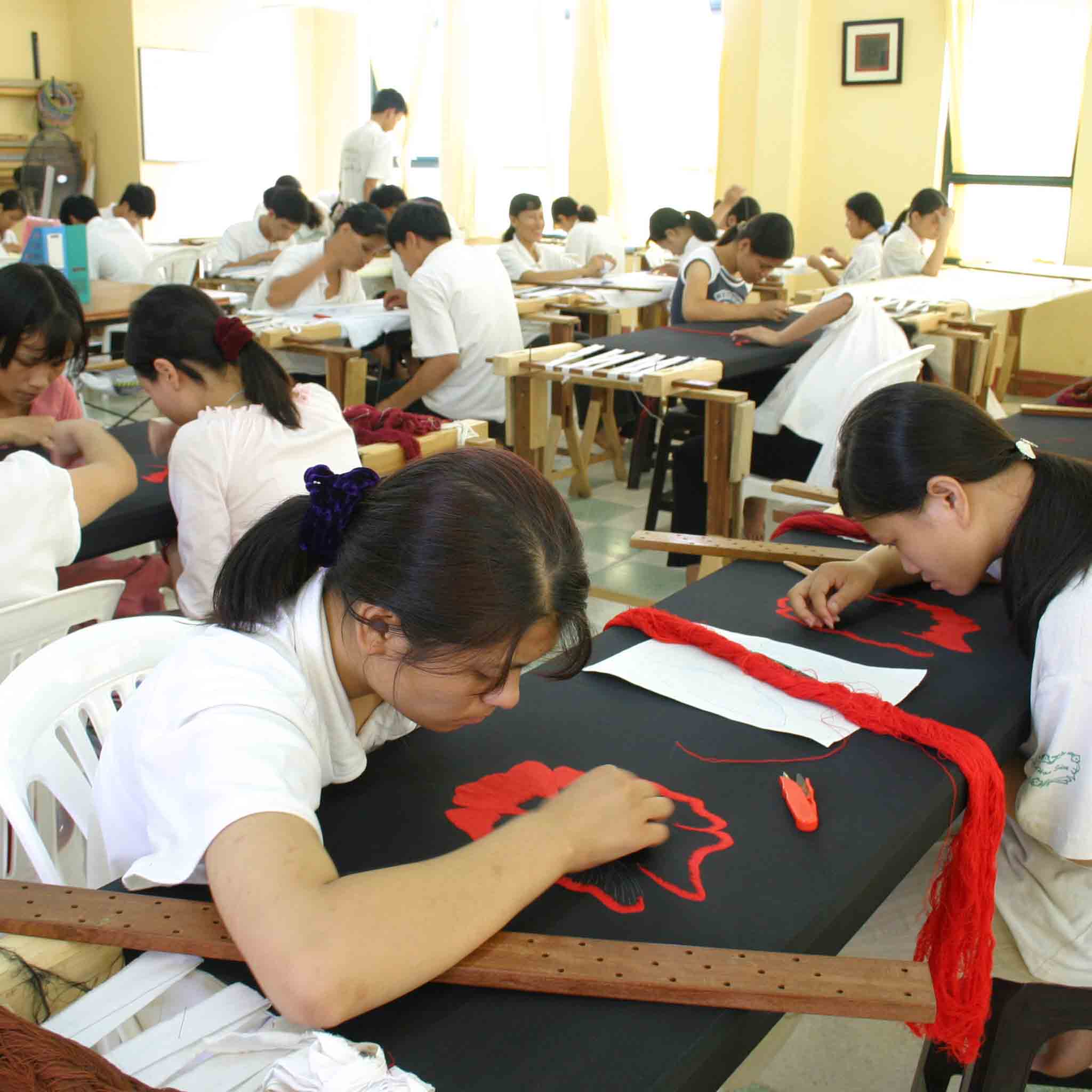 Students sewing in Hoa Sua's center for disabled