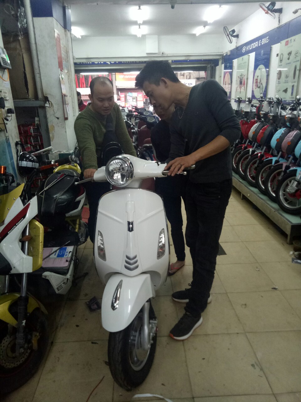 kĩ thuật viên hướng dẫn cách sử dụng xe cho khách hàng 