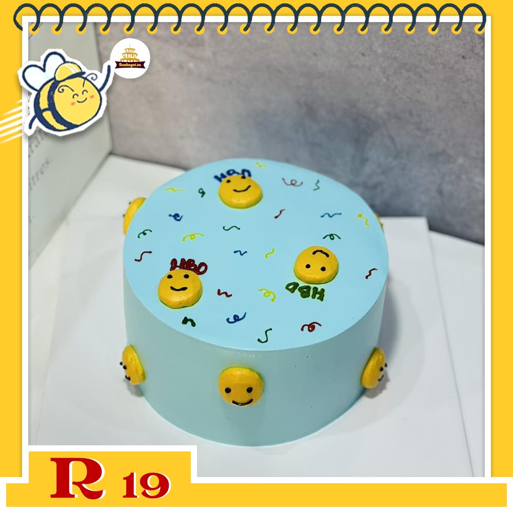 Bánh kem R19 nền xanh vẽ nhiều icon mặt cười màu vàng quanh bánh