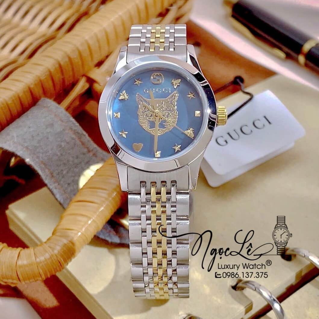 Đồng Hồ Gucci G-Timeless Mystic Cat Motif Dây Demi Vàng Mặt Xanh Size 28mm