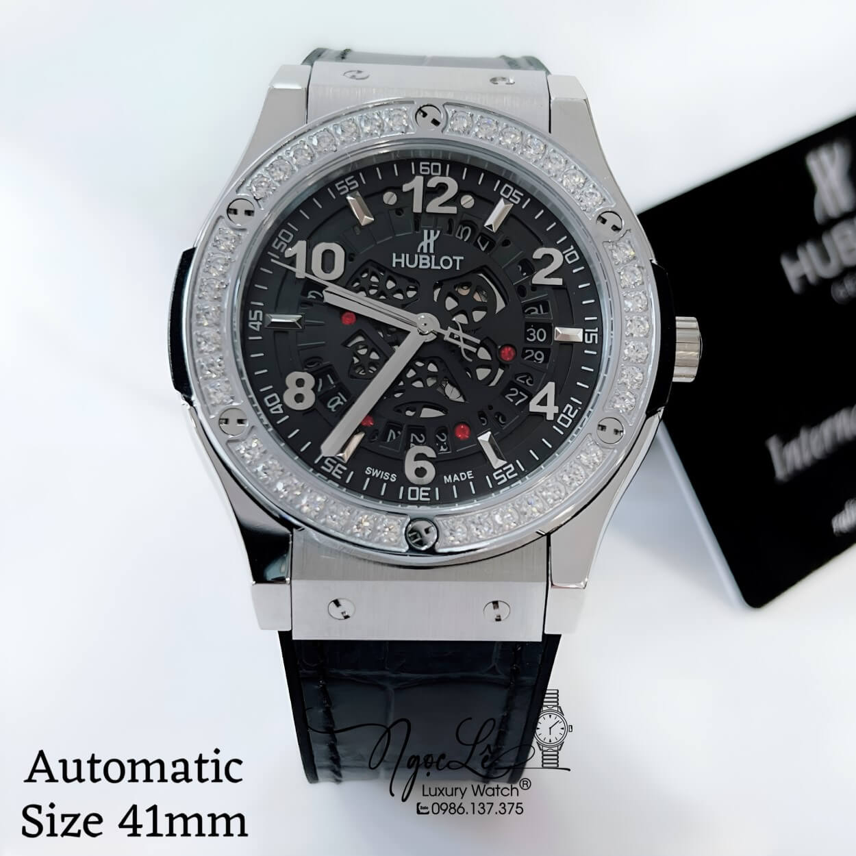 Đồng Hồ Hublot Nam Tự Động Lộ Máy Dây Da Silicon Đen Đính Đá Tròn Vỏ Silver Size 41mm