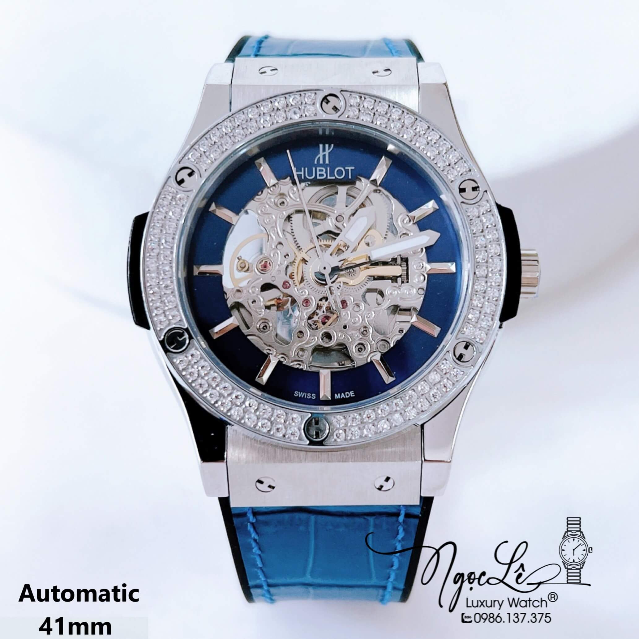 Đồng Hồ Hublot Nam Tự Động Lộ Máy Dây Da Silicon Xanh Dương Đính Đá Bạc Size 41mm