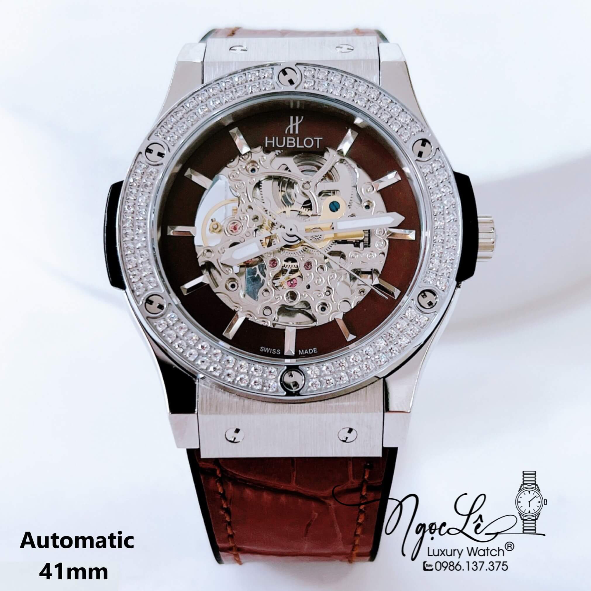 Đồng Hồ Hublot Nam Tự Động Lộ Máy Dây Da Silicon Nâu Đính Đá Bạc Size 41mm