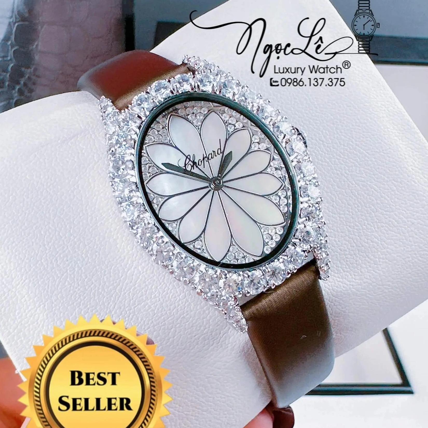 Đồng Hồ Nữ Chopard Mặt Oval Họa Tiết Hoa Xà Cừ Trắng Dây Da Lụa Màu Nâu Vỏ Silver Đính Đá Size 34mm