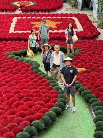 365Aplus Travel guide with guests at an incense village near Hanoi
