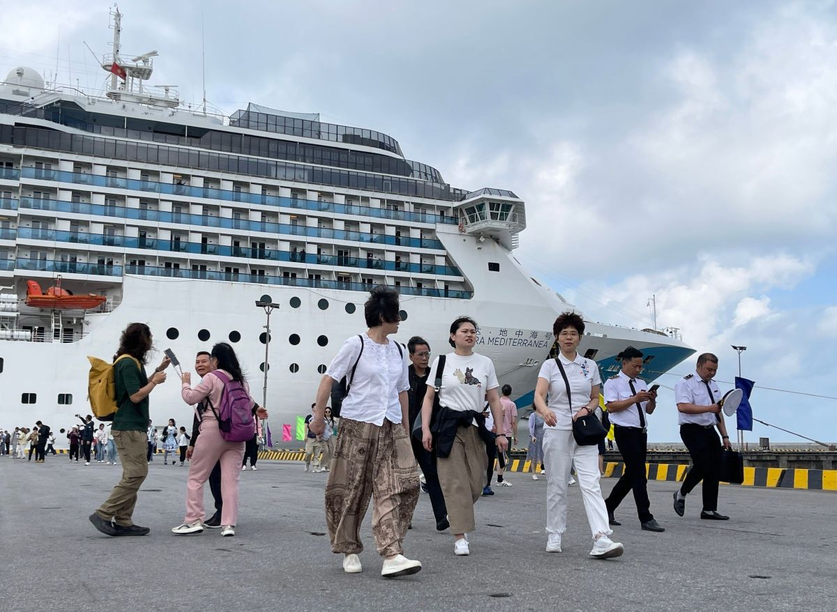 Cruise passengers walking along the pier on a shore day in Vietnam