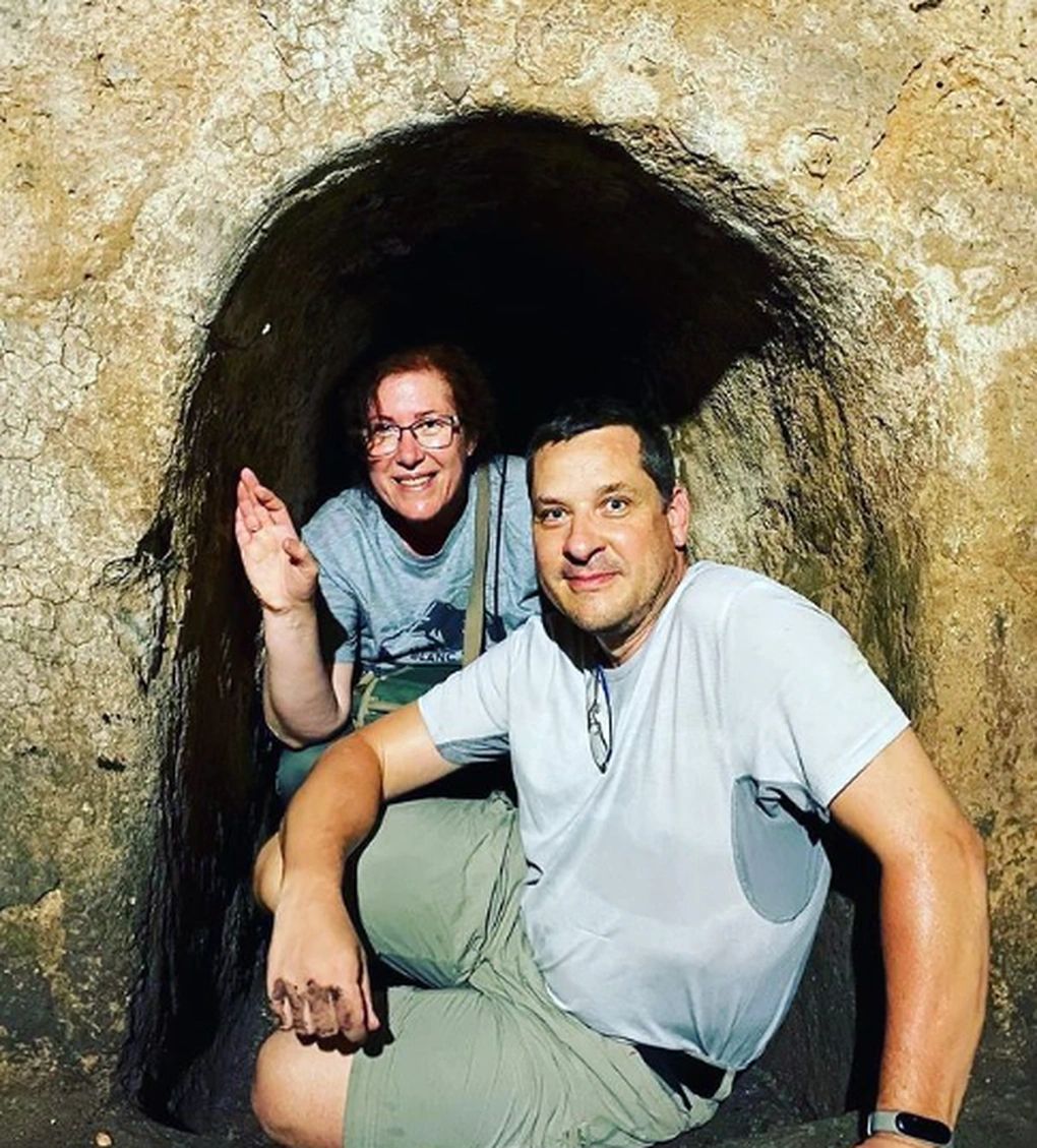 Visitors inside a Cu Chi tunnel entrance
