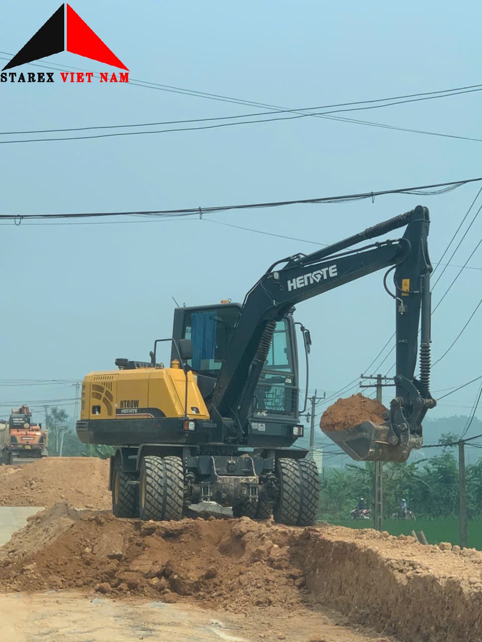 ban-giao-xe-dao-lop-03-hengte-ht80w-plus-2026-ve-du-an-mo-rong-duong-bo