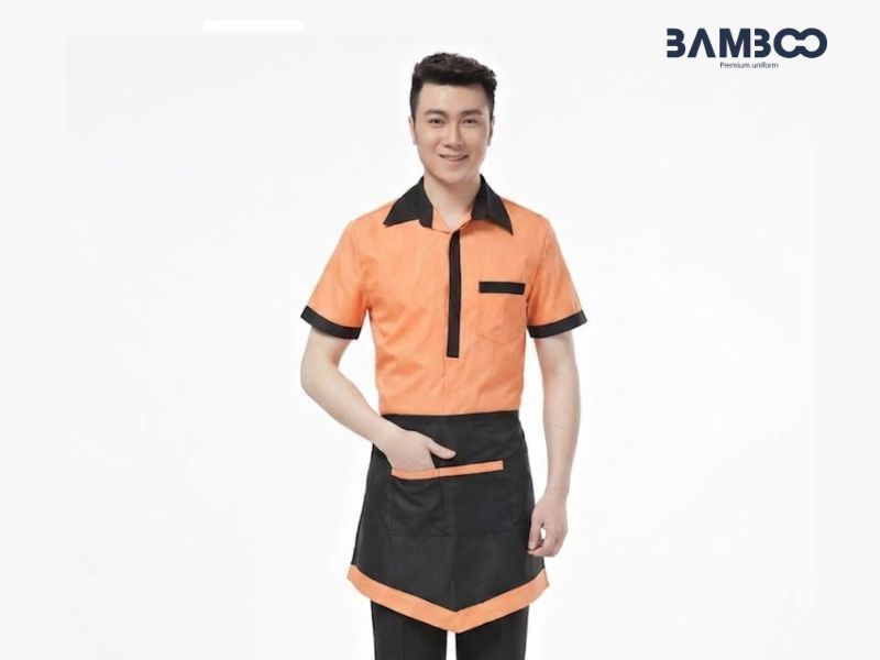 Chi phí may tạp dề đồng phục nửa thân dáng ngắn đen viền cam phụ thuộc vào yếu tố kỹ thuật và quy mô đơn hàng