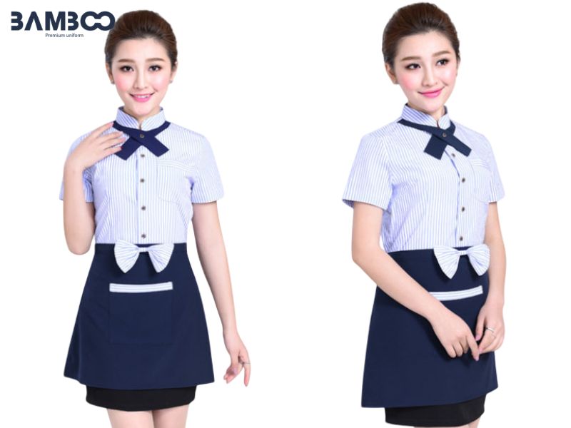Mẫu áo sơ mi nhân viên phục vụ nữ có thiết kế ôm vừa, cổ nơ cách điệu, phối tạp dề thanh lịch