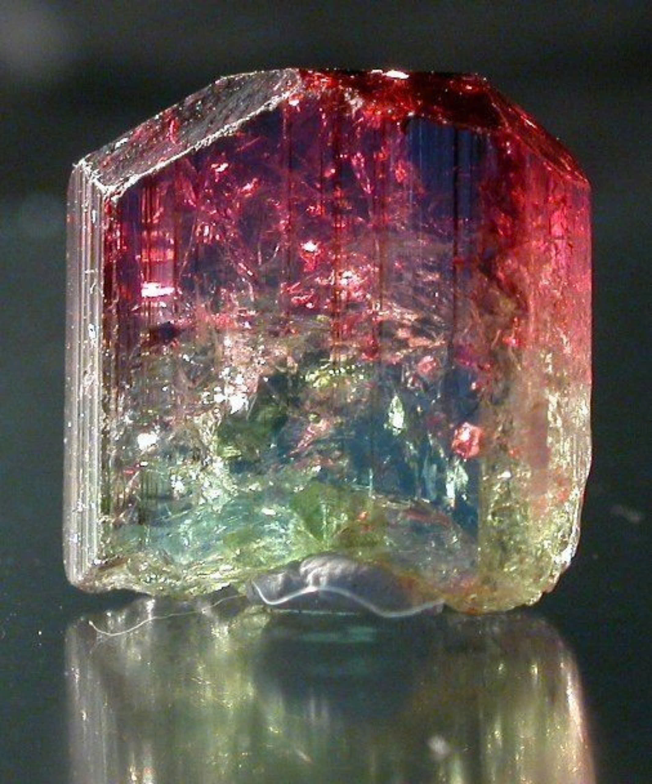 Tinh thể Tourmaline lưỡng sắc đỏ v&agrave; lục c&ograve;n th&ocirc;, nh&igrave;n r&otilde; c&aacute;c bao thể b&ecirc;n trong vi&ecirc;n đ&aacute;